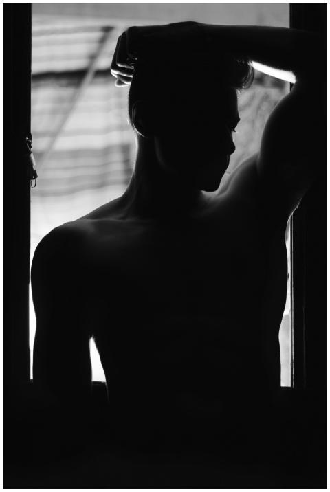 Dramatic black and white silhouette of a shirtless
