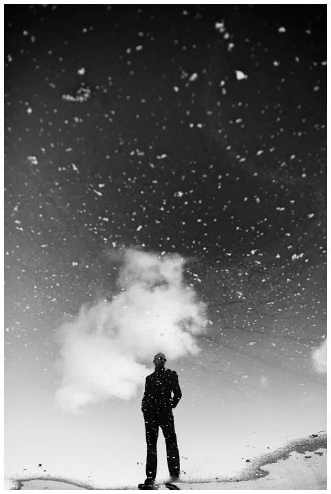 Black and white photo of a man silhouetted against