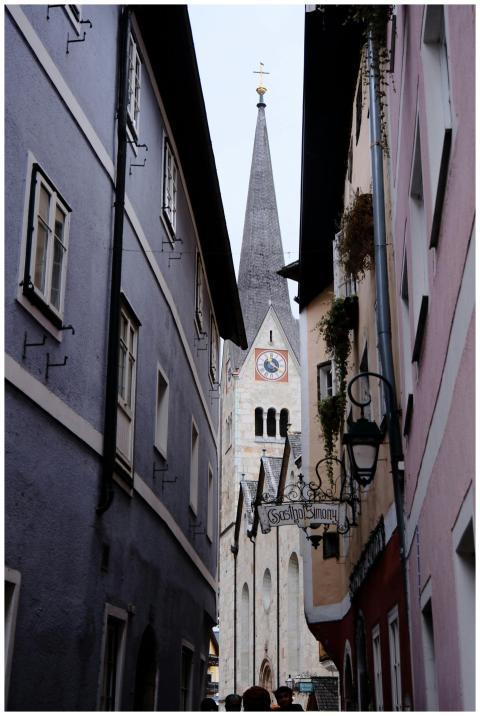 Narrow alley view leading to a historic European c