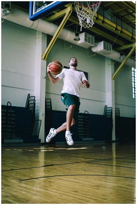 Dynamic shot of an athlete poised to dunk a basket