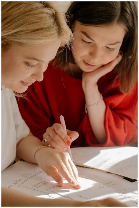 Two college students studying together, focusing o