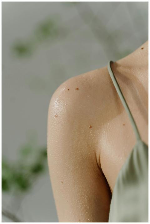 Detailed close-up of a woman's shoulder with sweat
