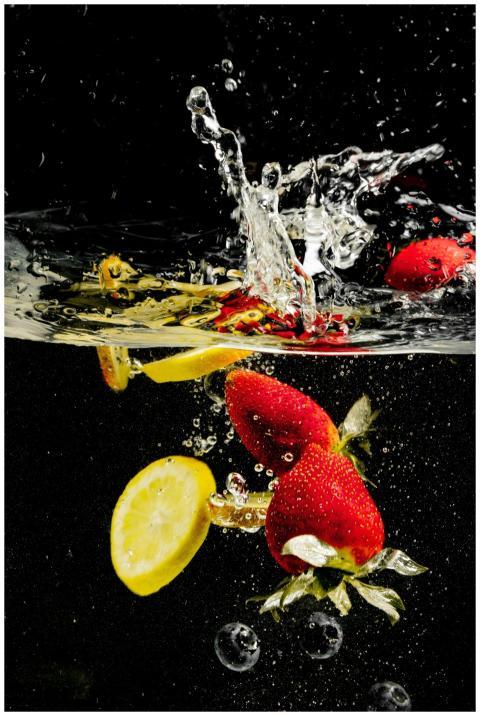 Dynamic underwater splash showcasing fresh strawbe