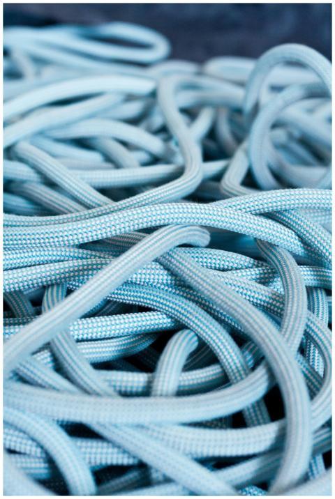 Detailed view of blue climbing rope tangled on a s