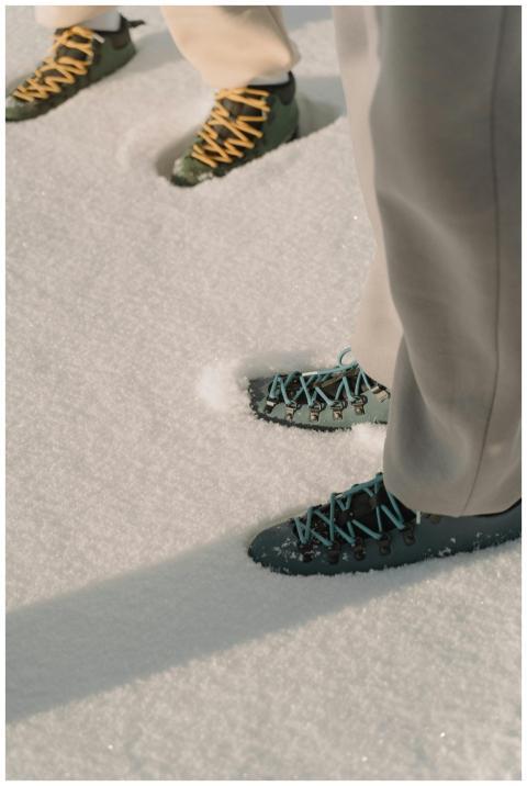 Two pairs of hiking boots with colorful laces on p