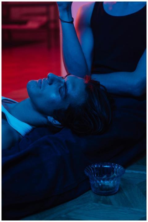 An artistic portrait of a man resting indoors with