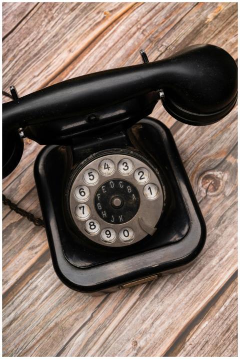 Close-up of a vintage rotary telephone on a wooden