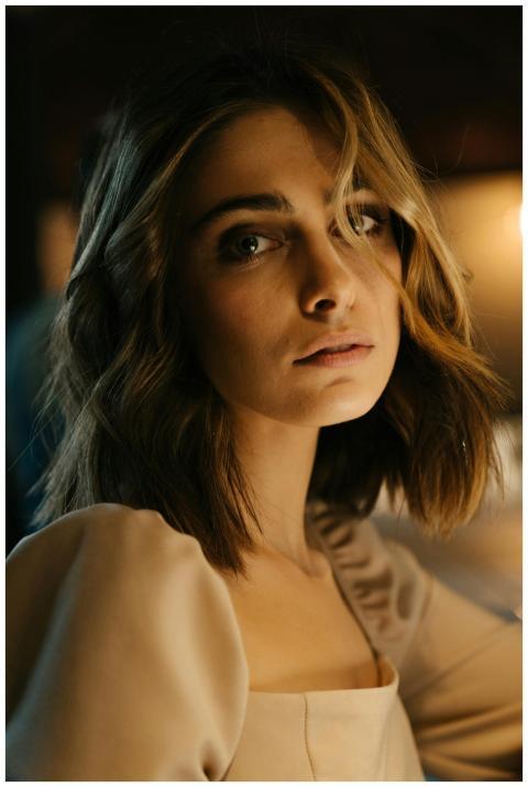 Portrait of an elegant woman sitting at a bar coun