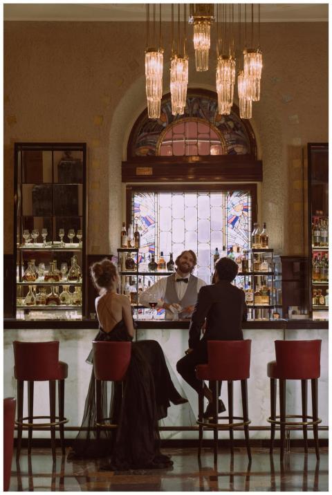 A couple enjoying a drink at a luxurious bar with