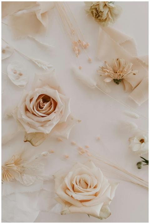 A delicate arrangement of pastel roses and dried f