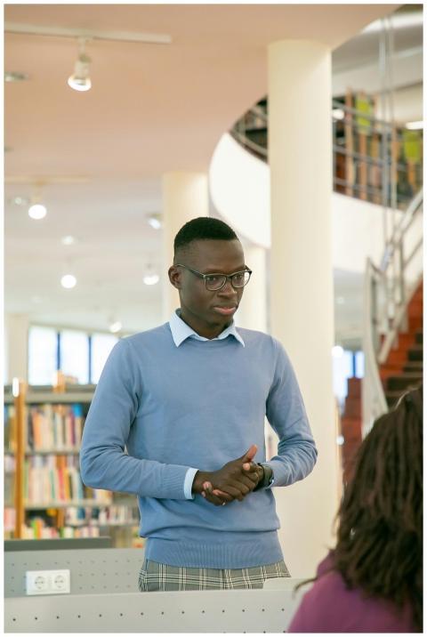 A young man gives a presentation in a university l