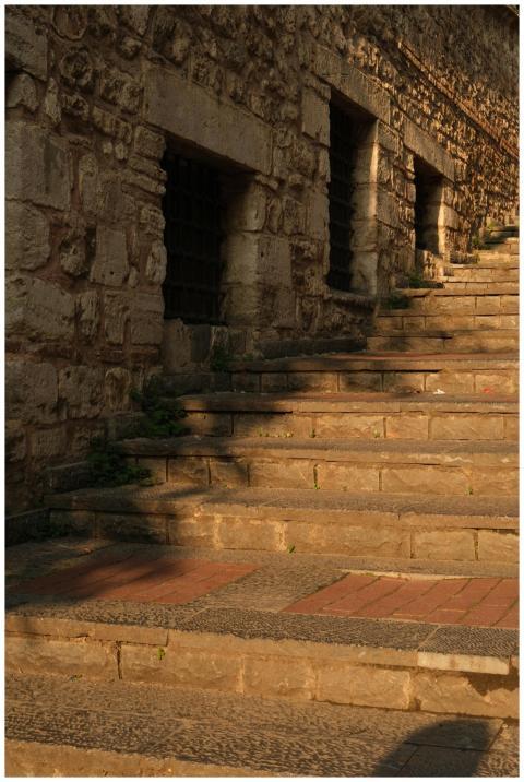 An ancient stone staircase with warm lighting, sho