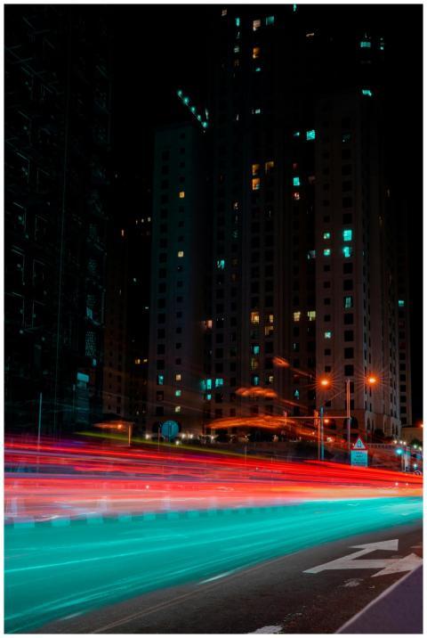 Dynamic cityscape showcasing colorful light trails