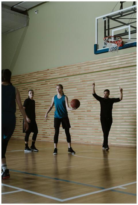 Group of young basketball players practicing on an