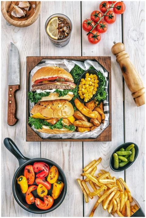 A mouth-watering gourmet burger meal with fries, p