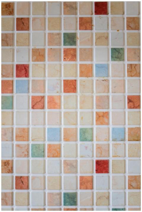 A vibrant mosaic tile wall with multicolored geome