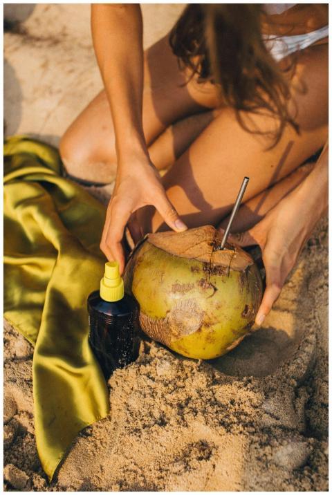 A relaxing beach scene featuring a woman holding a