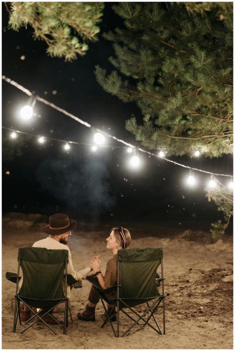 Couple enjoying a cozy campfire night with string