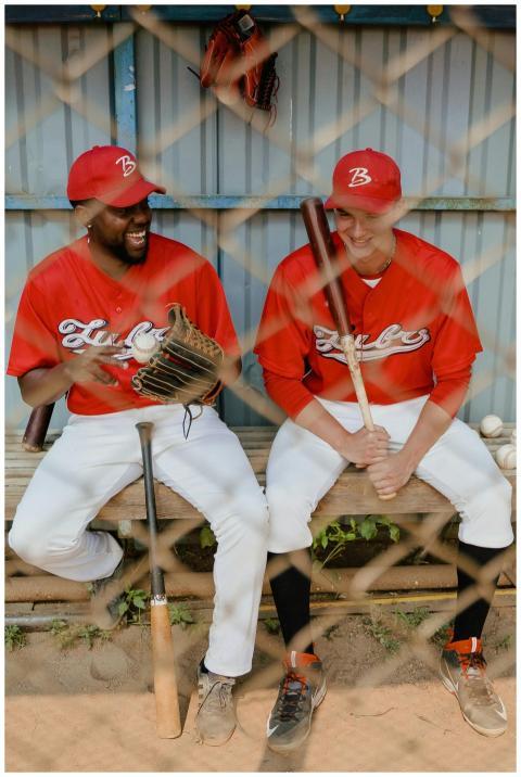 Two baseball players in uniform share a light-hear