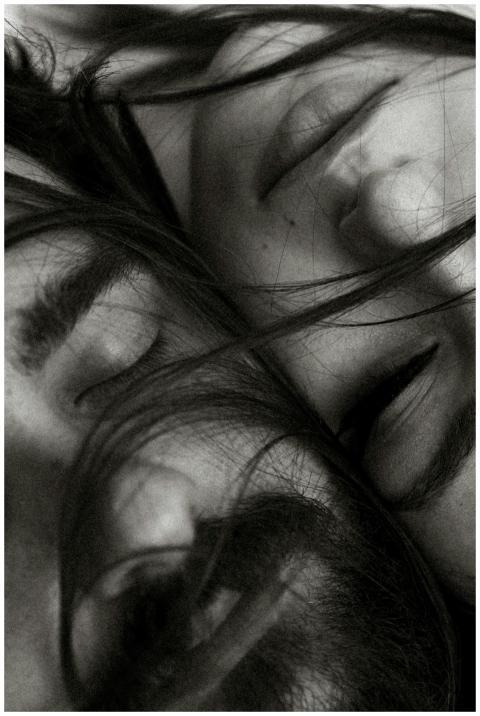 Close-up black and white portrait of two people wi