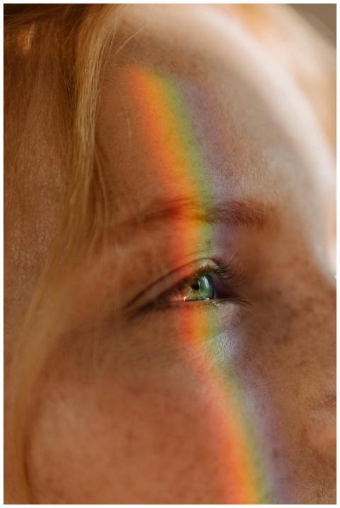 Artistic close-up of a freckled face with vibrant