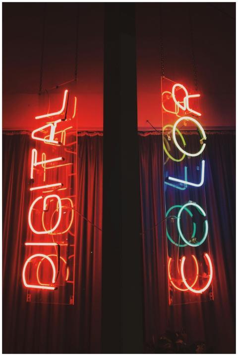 Red and colorful neon signs displaying the words '