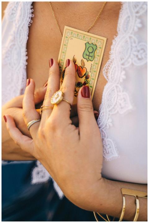 Close-up of woman holding tarot card to her chest