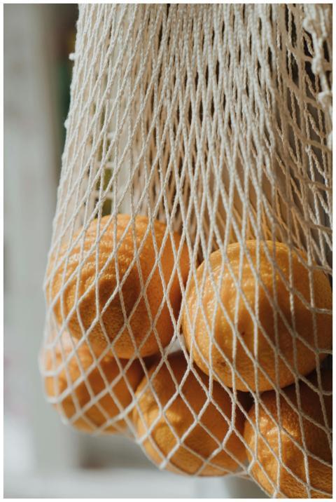 Close-up of oranges in an eco-friendly string bag,
