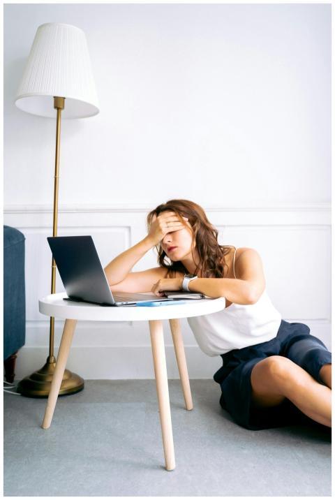 A woman showing signs of fatigue while working rem