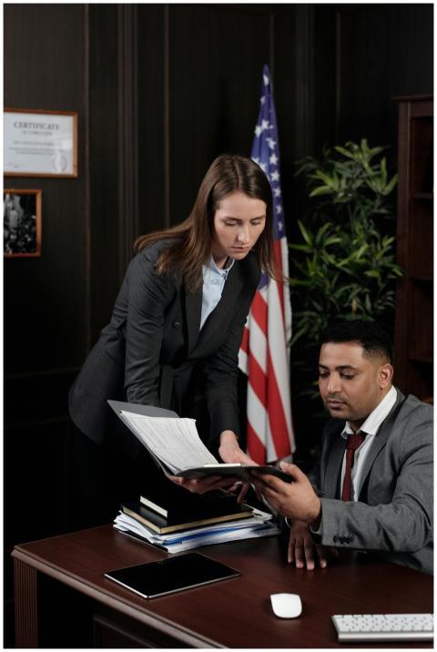 Business professionals discussing documents in a U