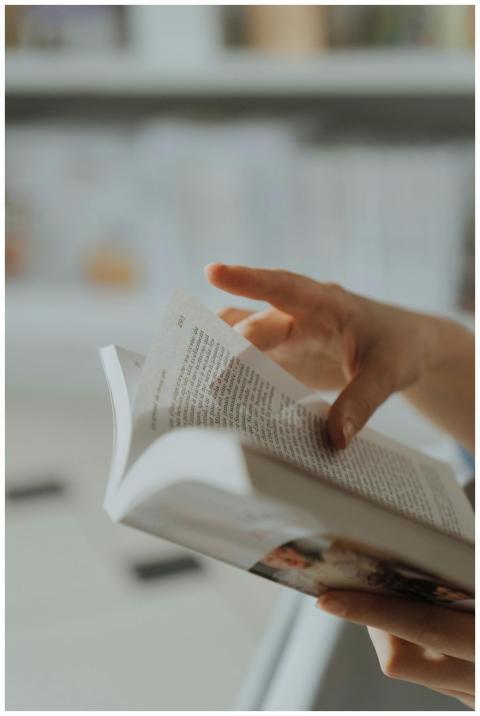 Close-up of a hand flipping pages in a bookstore s