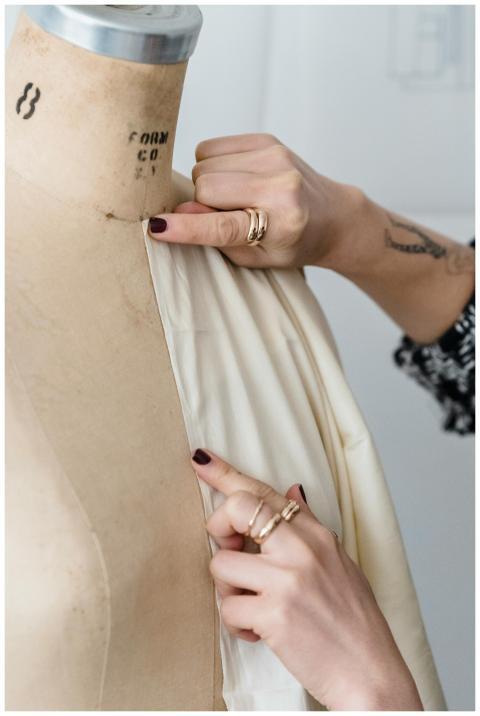 Crop anonymous tattooed female designer in rings m
