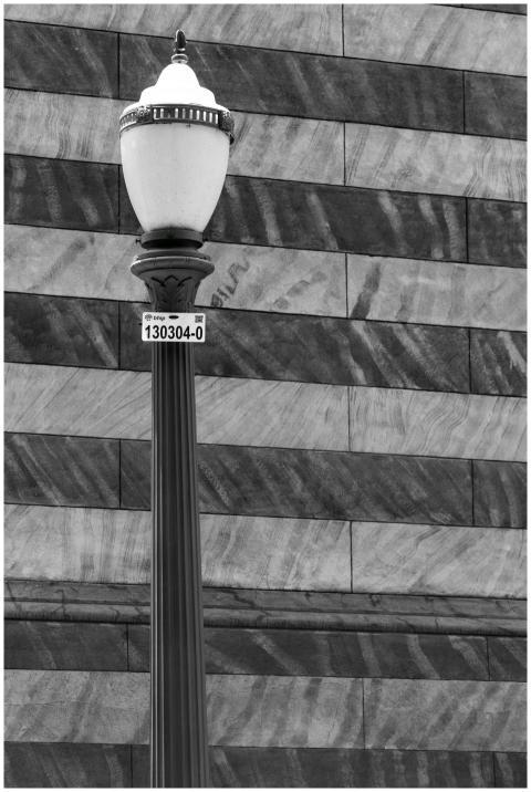 Black and white image of a vintage-style street la