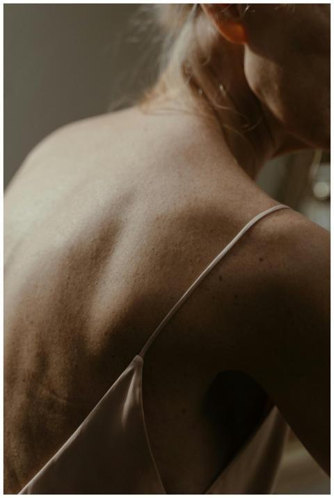 A close-up view of a woman's back with soft, natur