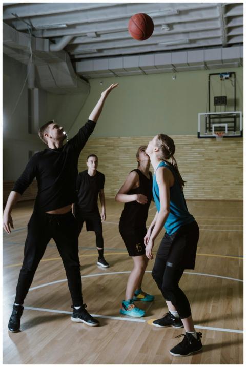 Dynamic scene of players engaged in an indoor bask