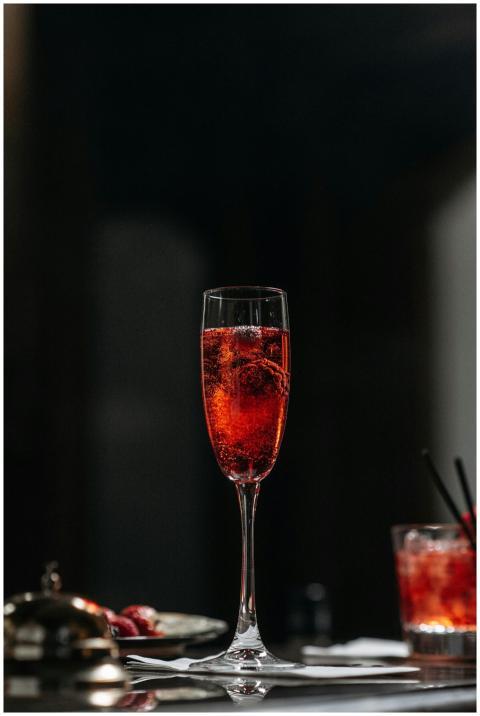 A chic and elegant flute of sparkling red cocktail