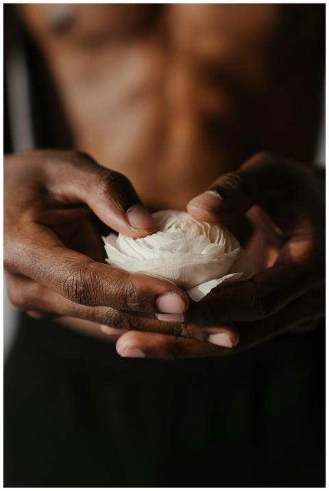 A close-up of a person holding a delicate white ra
