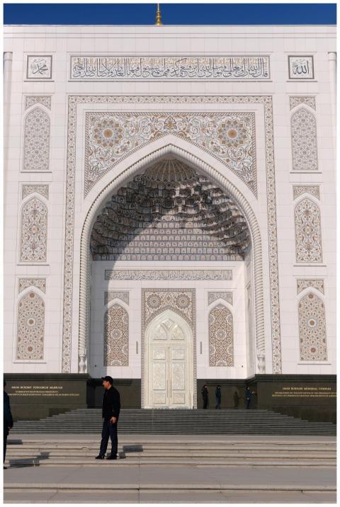 A grand mosque entrance adorned with intricate geo