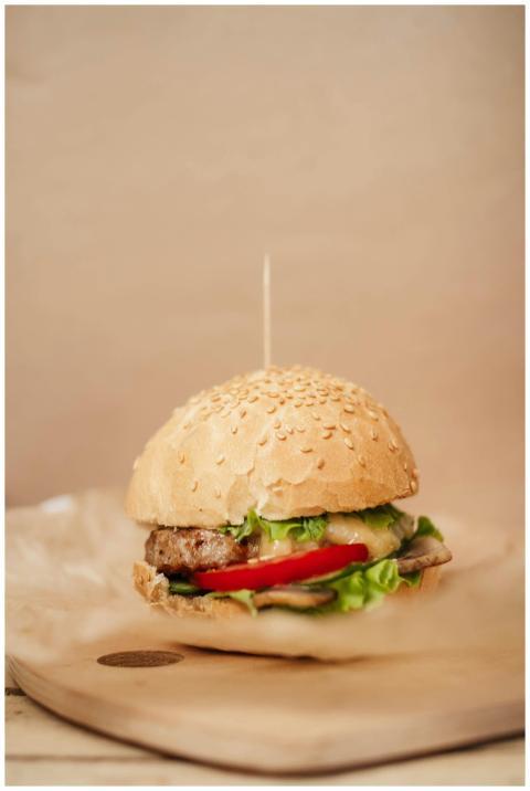 Tasty burger with juicy patty and tomato slice bet