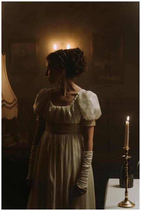 Elegant woman in period costume with candlelight a