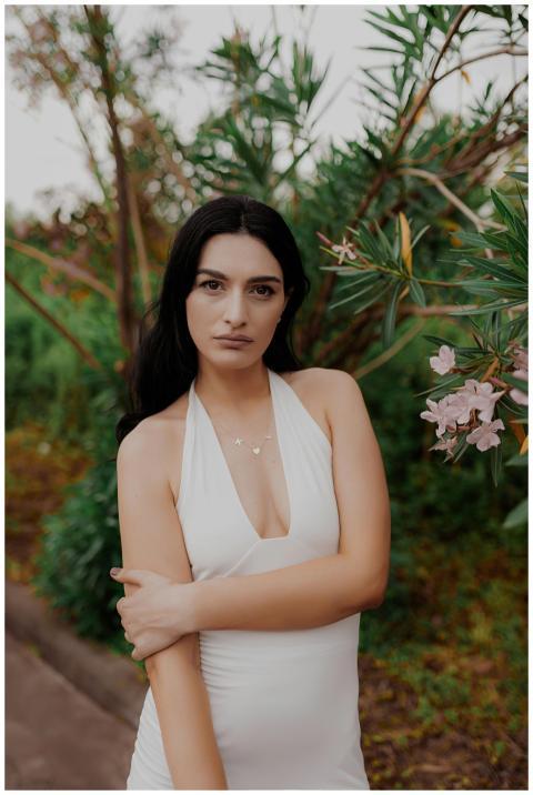 A stunning portrait of a woman in a white dress am