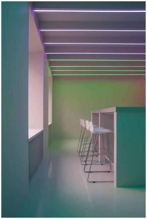 A sleek modern bar interior with neon lighting and