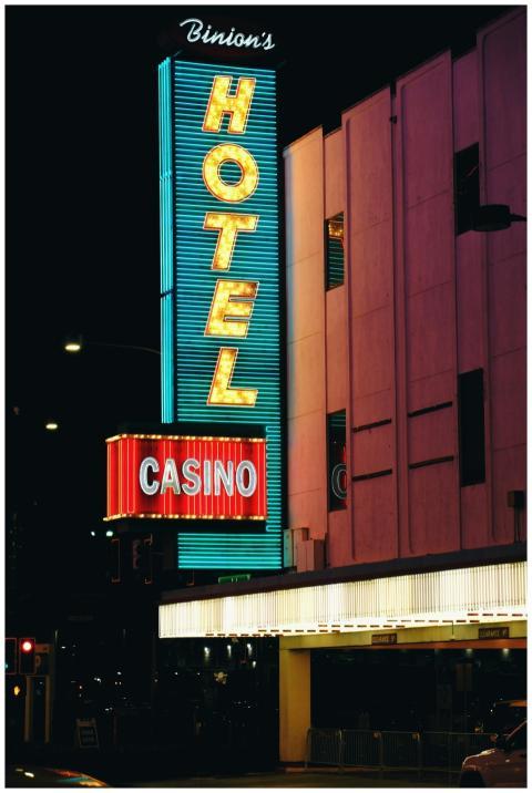 Neon-lit Casino and Hotel sign at night in downtow