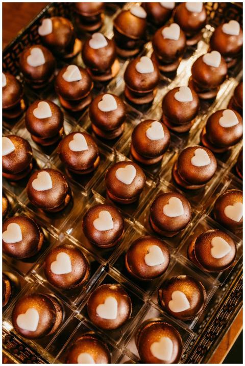 Delicious chocolate bonbons with heart decorations