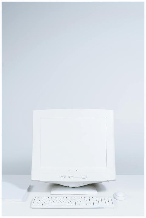 A clean, minimalist white desktop computer setup w