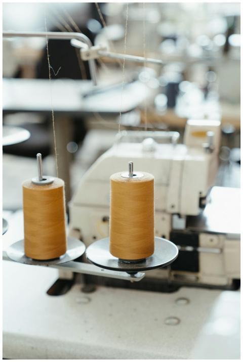 Detailed view of a sewing machine with spools of t