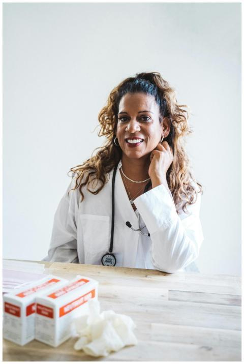 Smiling female doctor in a lab coat with a stethos