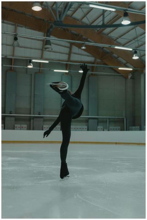 Figure skater performing a graceful spin in an ind
