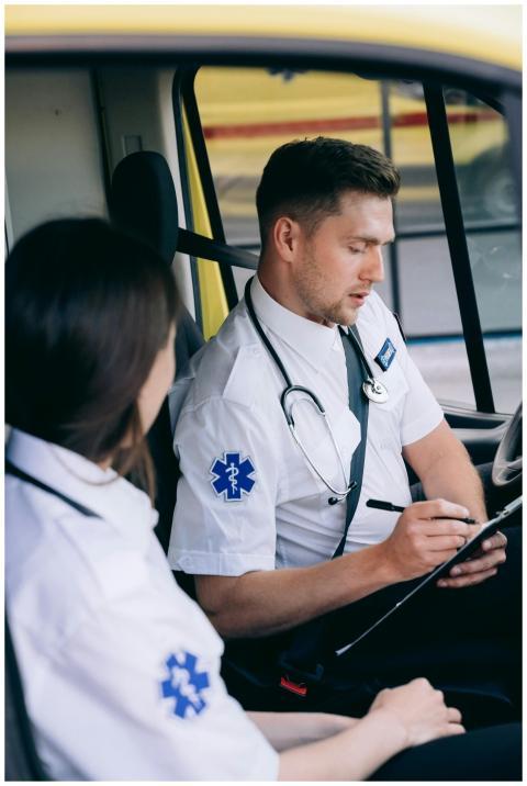 Paramedics in an ambulance reviewing notes during
