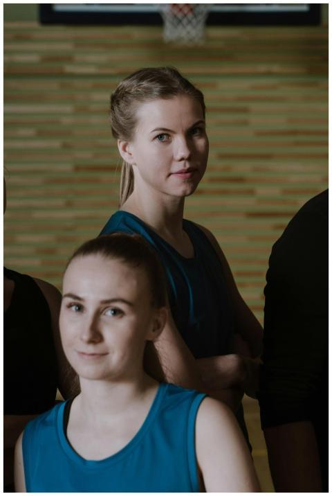 Two young female basketball players pose confident